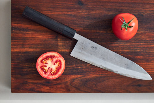 Tomato fruit on wood chopping board