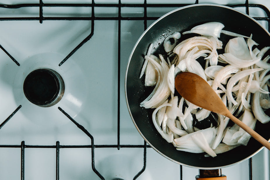 Chopped onions cooking over gas stove