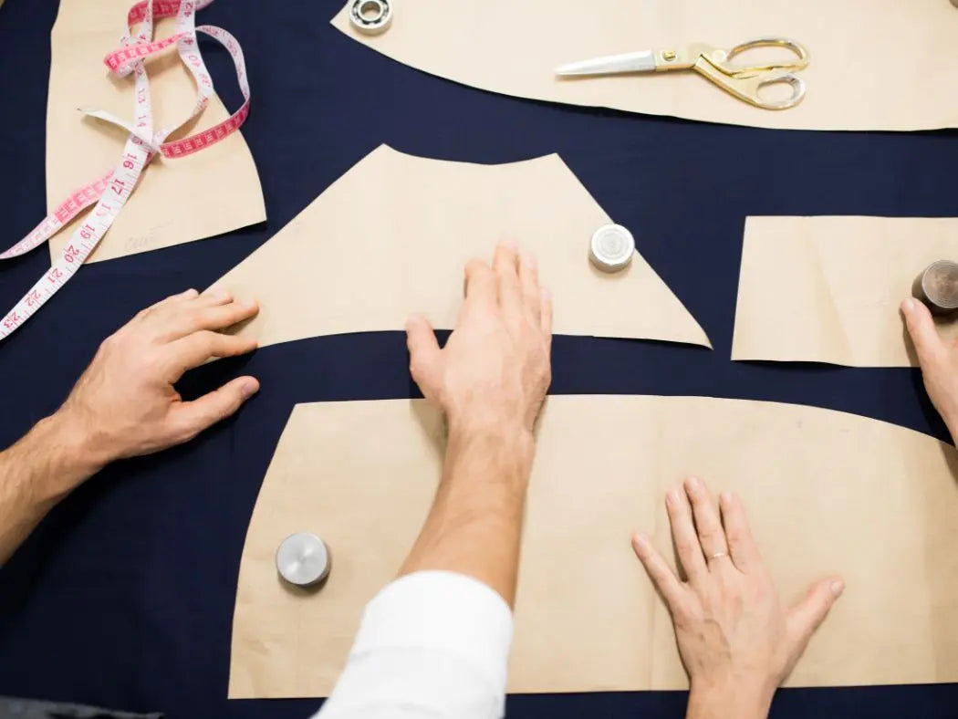 Sewing Pattern Weights being used on fabric. scissors and measuring tape visible
